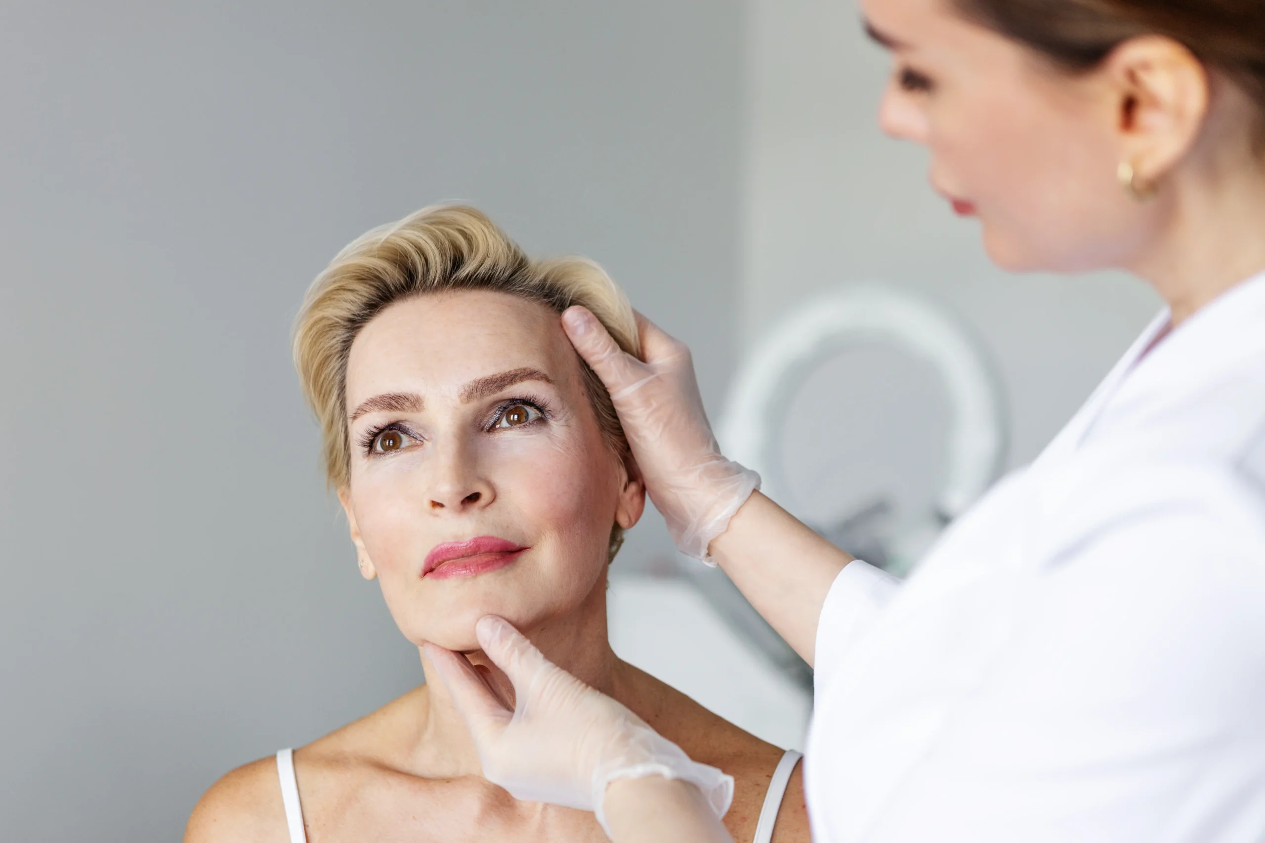 Middle-aged woman at a cosmetic surgery consultation